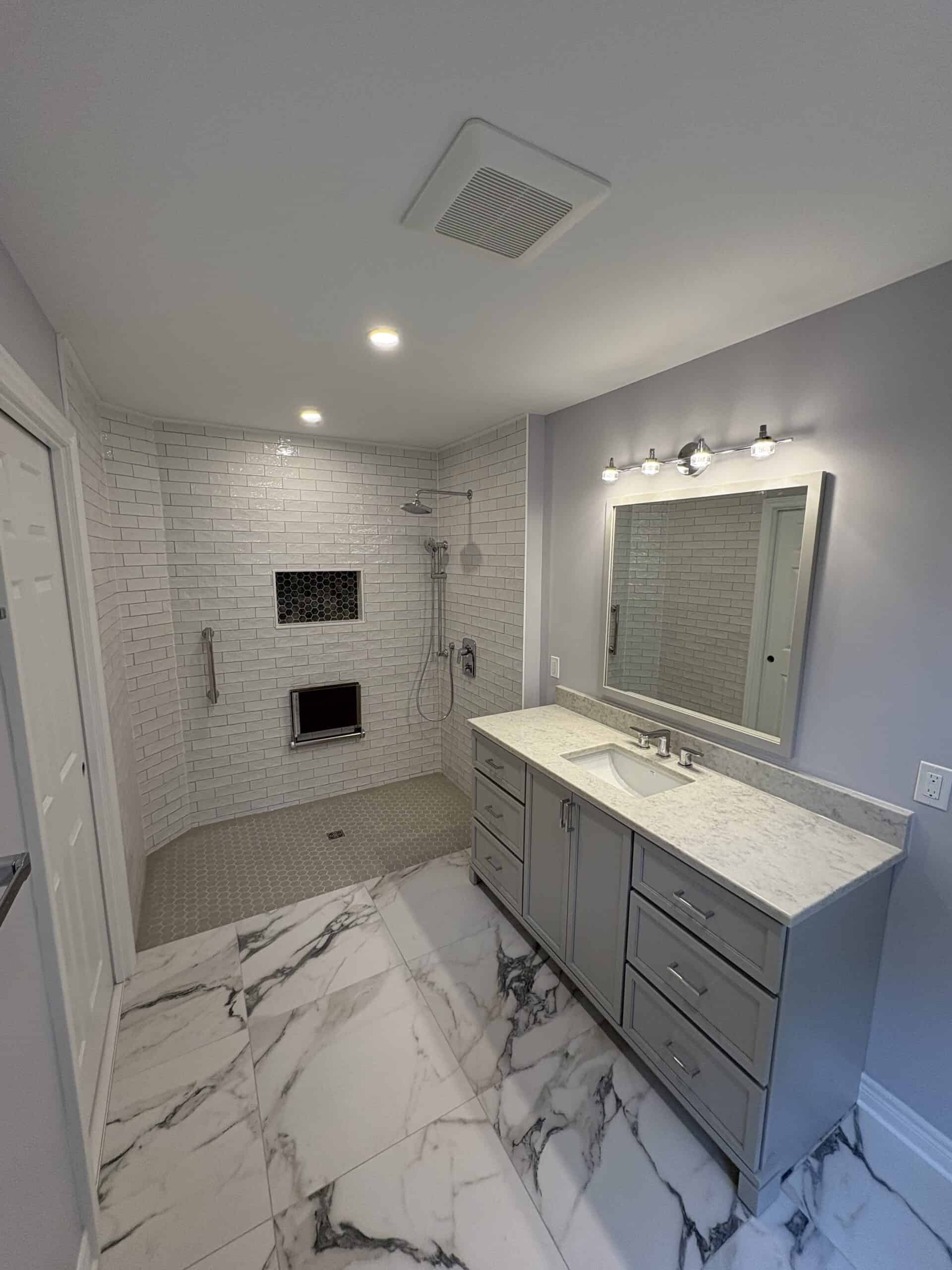 Modern bathroom with walk-in shower, marble flooring, and contemporary vanity.